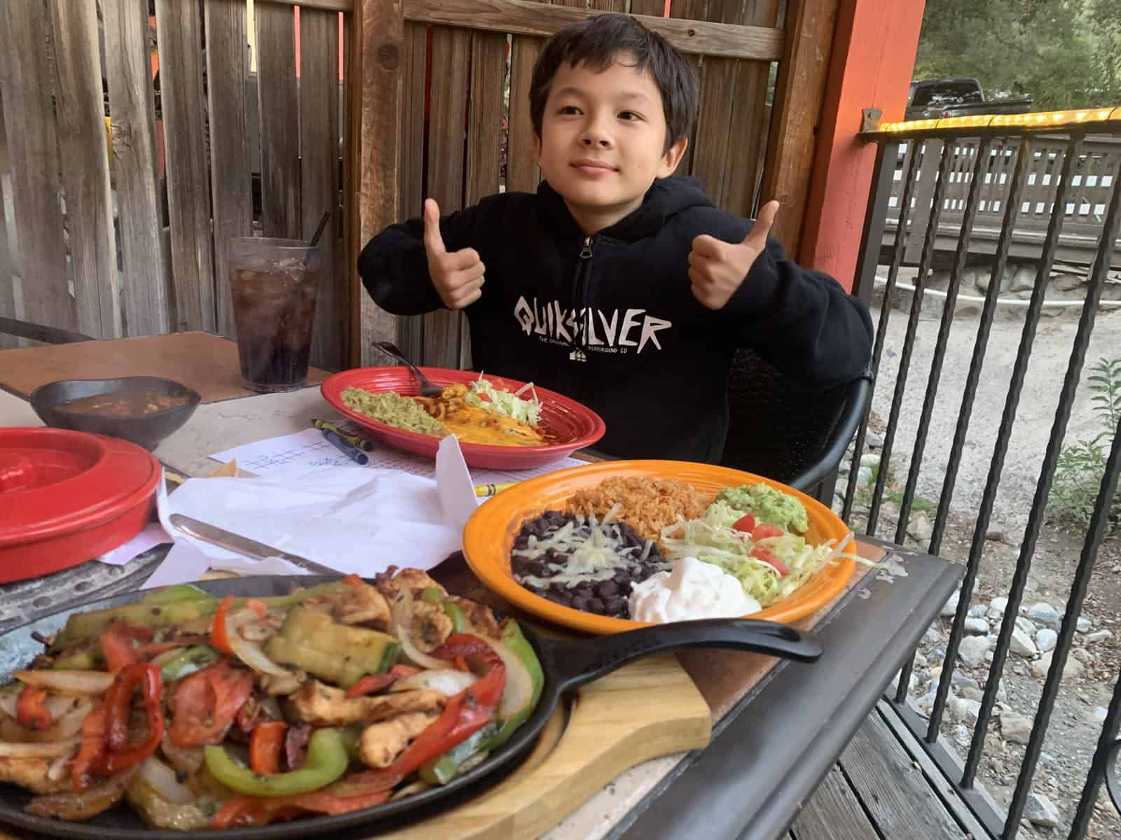 My son gives thumbs up for the food at Rose Canyon Cantina