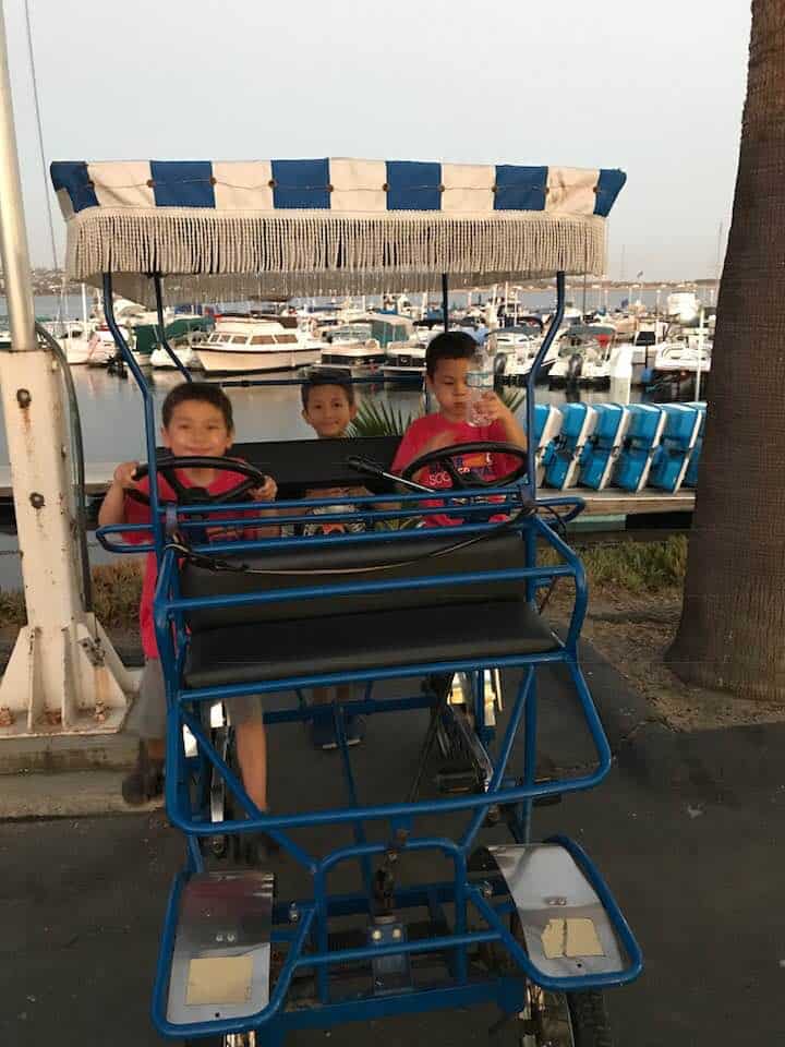kids riding a surrey at Campland on the bay