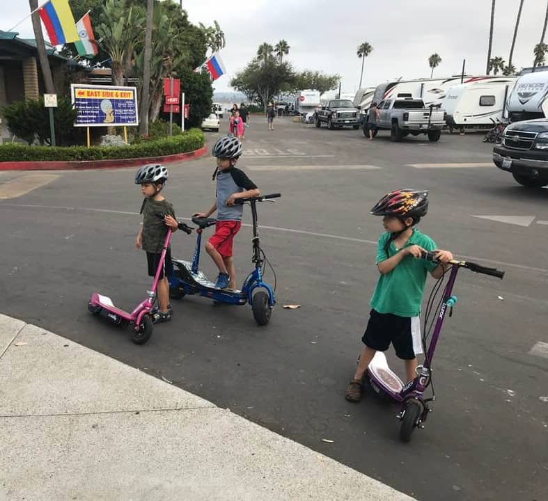 kids riding scooters at Campland on the Bay