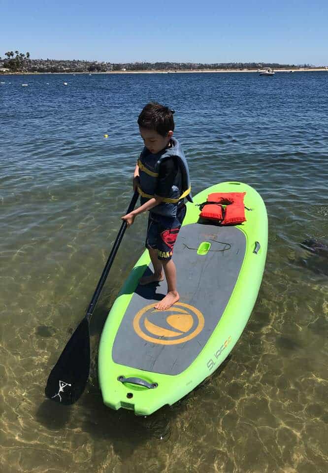 my son paddleboarding at Campland