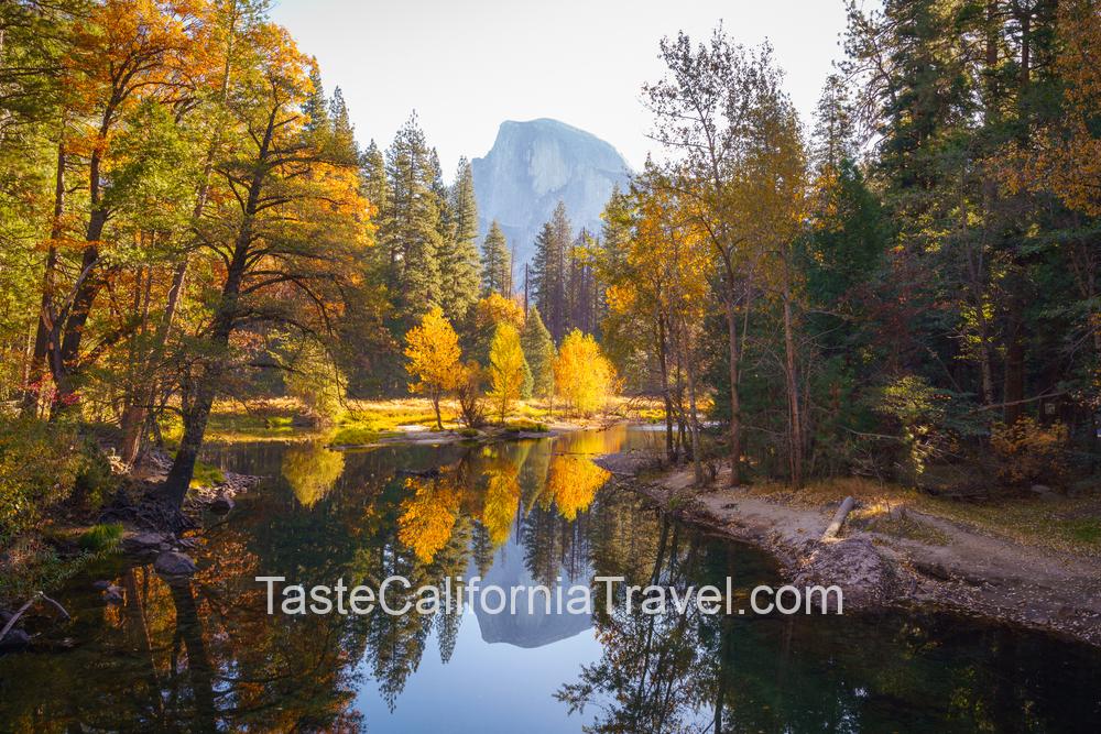 Yosemite Valley river with reflection of Half-Dome and autumn trees