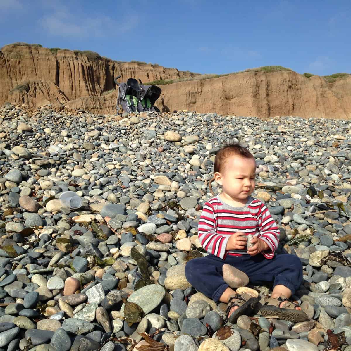 my kid playing with rocks at san onofre beach